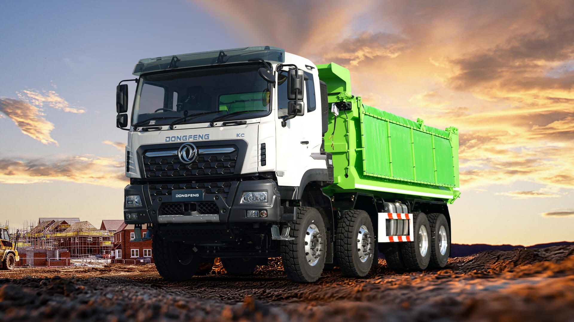 Dongfeng tipper truck with a green body on a building site at sunset